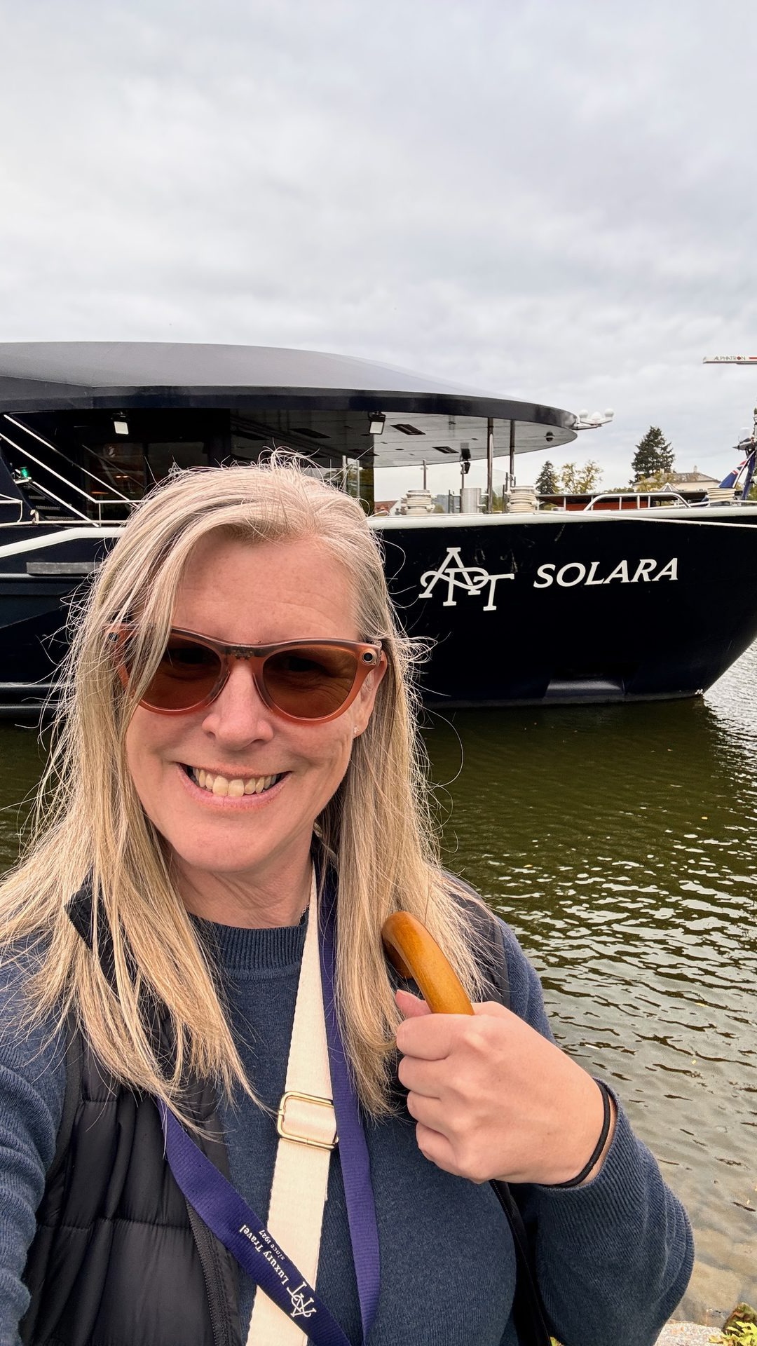 Travel advisor Annie Schlegel standing in front of the APT Solara river cruise ship on the Main River in Miltenberg, Germany