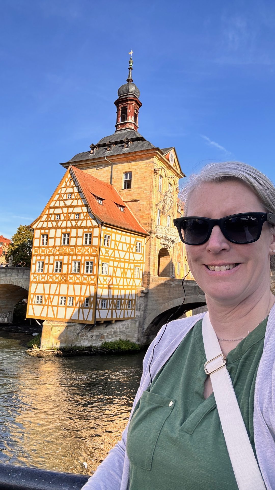 Travel advisor Annie Schlegel in front of the Old Town Hall on the Regnitz River in Bamberg, Germany, on an APT river cruise