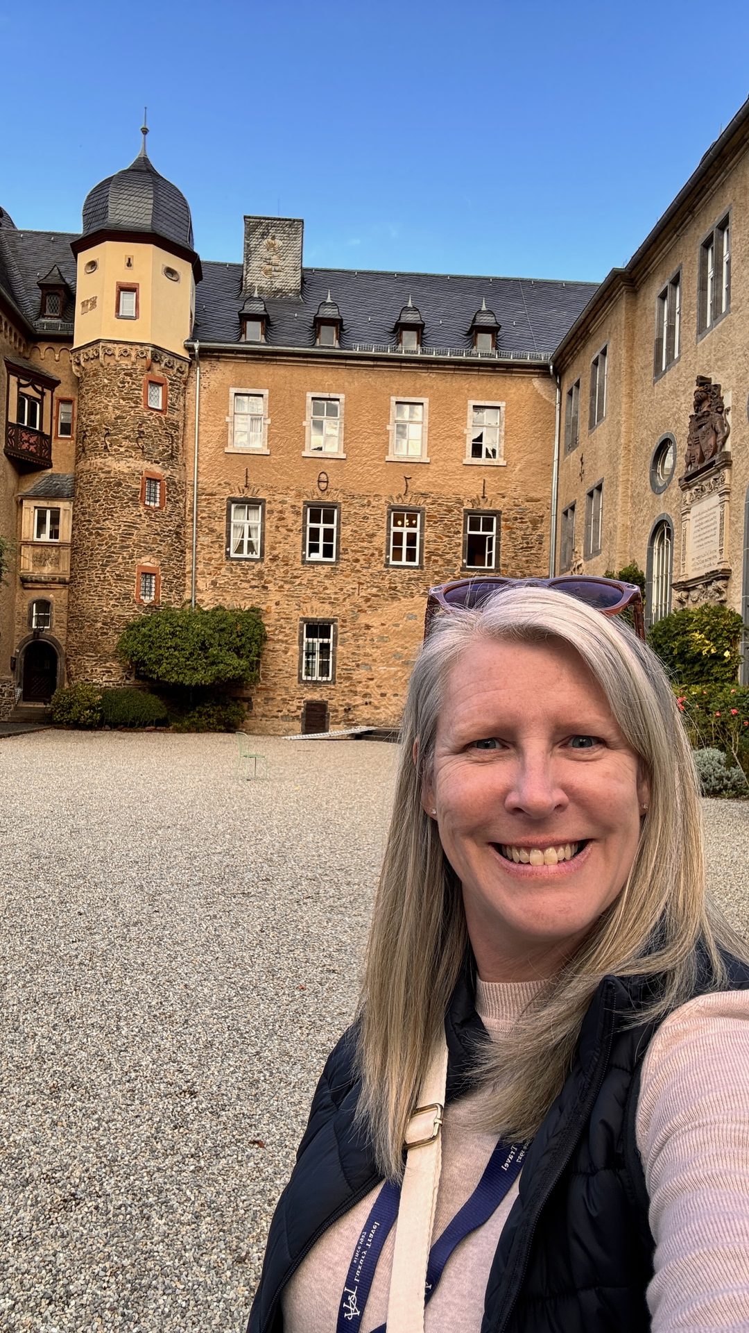 Travel advisor Annie Schlegel in the courtyard of Namedy Castle near Andernach, Germany, during an APT river cruise Signature Experience