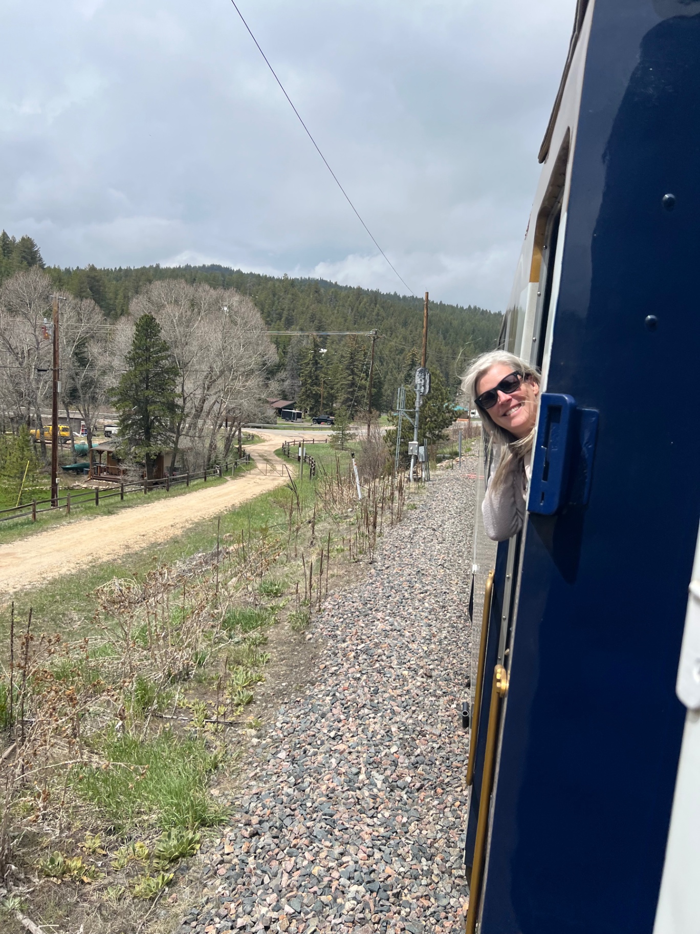 Travel advisor peeking out from the Rocky Mountaineer train in the Canadian Rockies