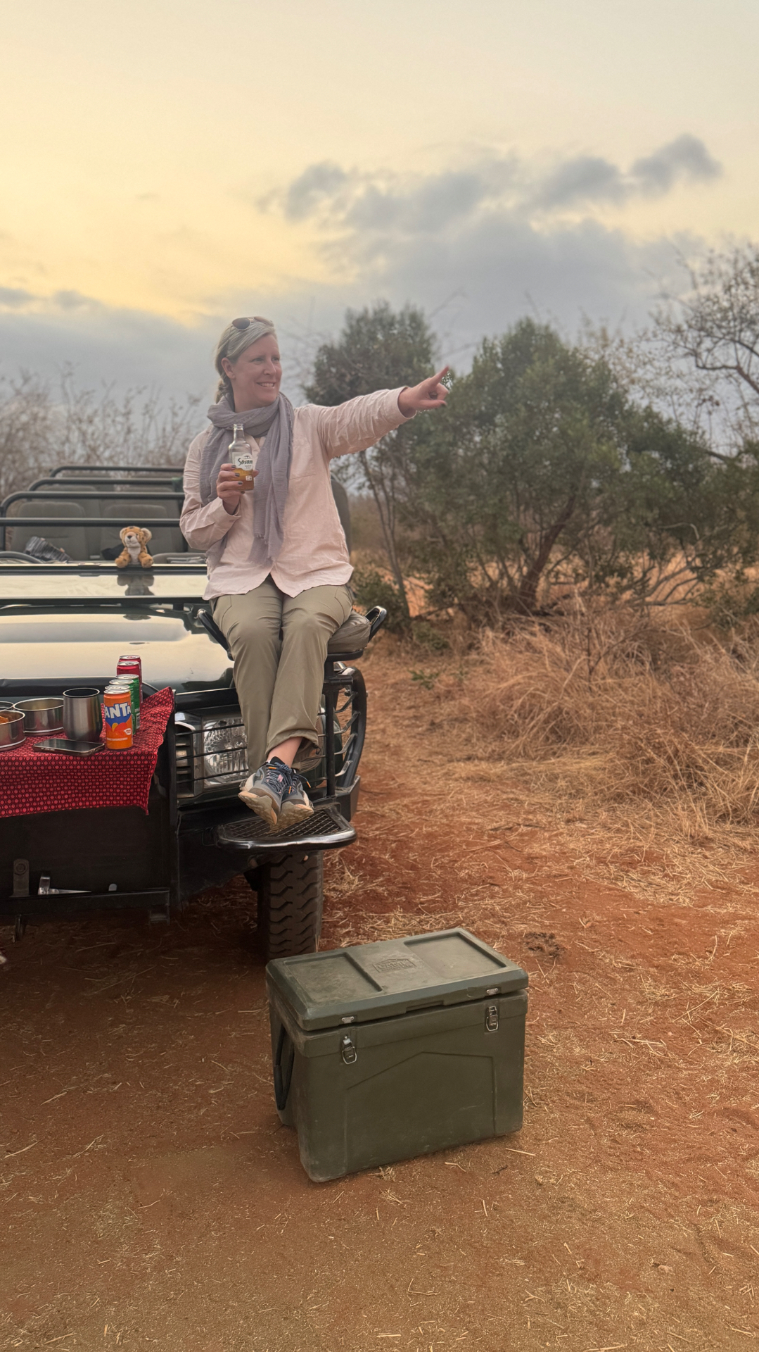 Travel advisor Annie Schlegel on a safari jeep with elephants crossing the road in South Africa