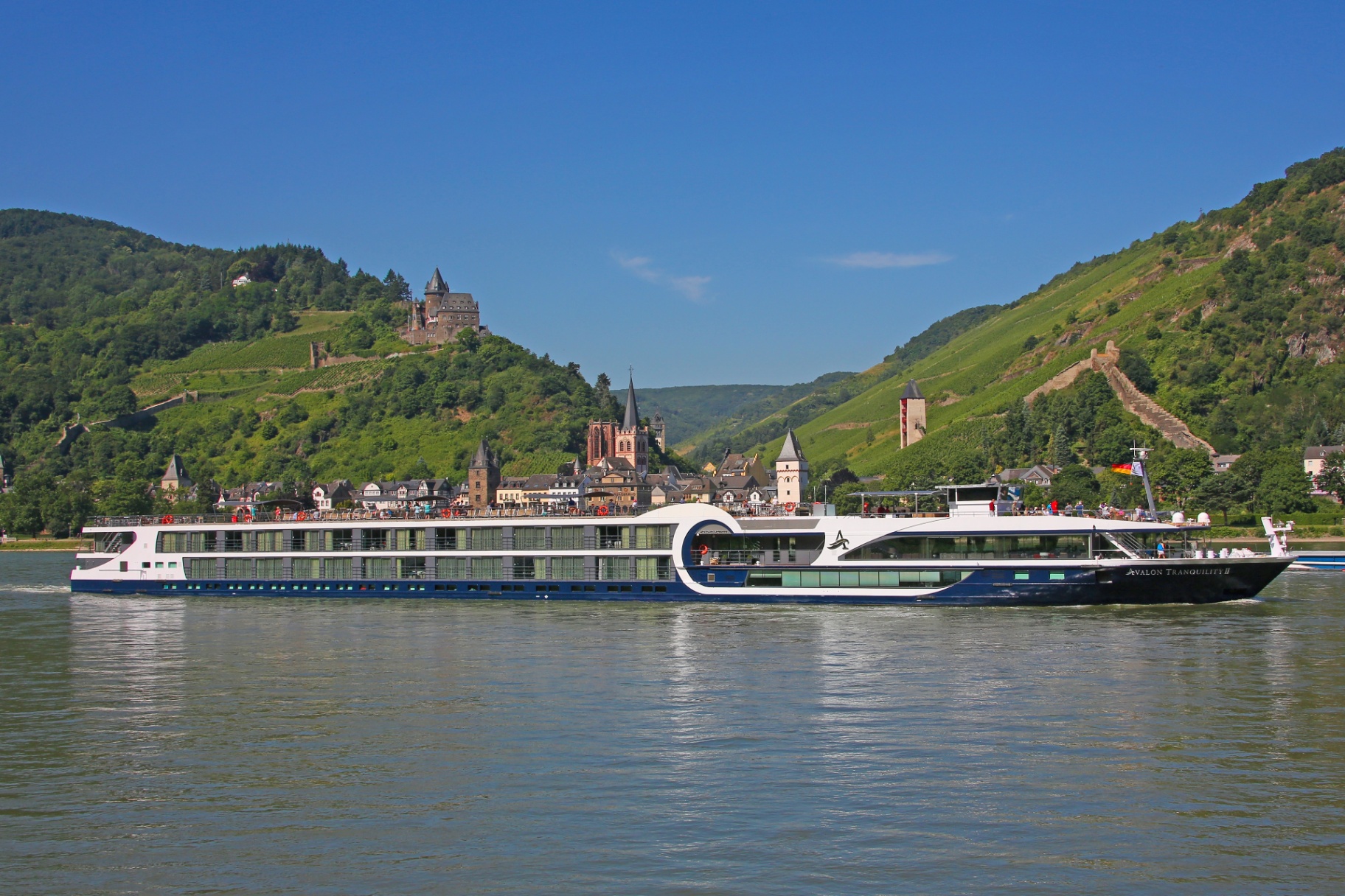 Avalon Tranquility II river cruise ship sailing the Rhine past a German hillside village - Suite Impressions Travel