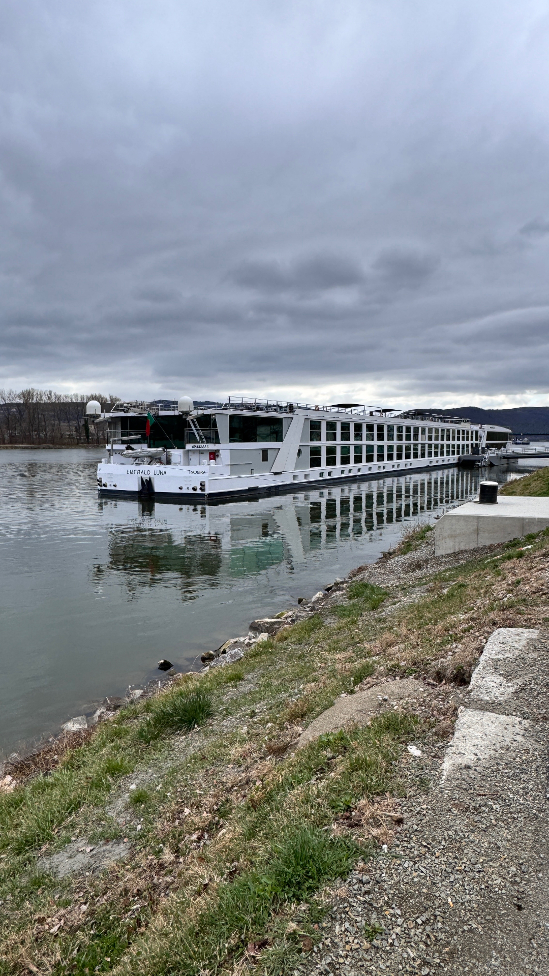 Emerald Luna river cruise ship docked along a European riverbank - Suite Impressions Travel