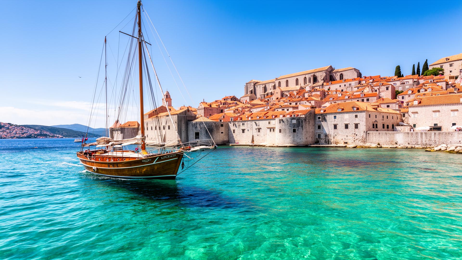 Small sailing ship cruising the crystal clear Adriatic coast of Croatia